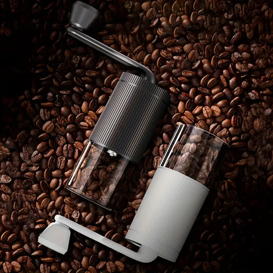 Handheld coffee grinder on a bed of coffee beans